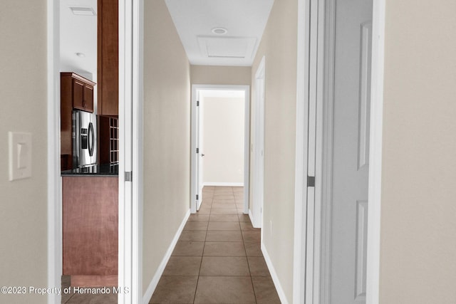 corridor with dark tile patterned floors