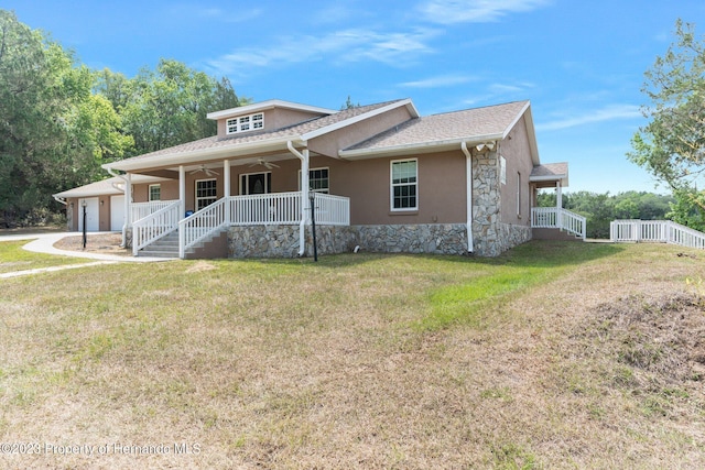 view of front of property featuring a front lawn and a garage