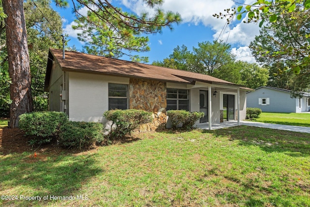 ranch-style home with a front lawn