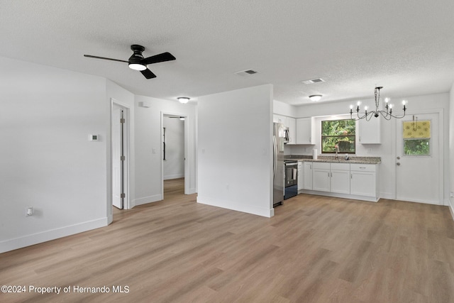 kitchen featuring light wood-type flooring, pendant lighting, stainless steel appliances, and white cabinets