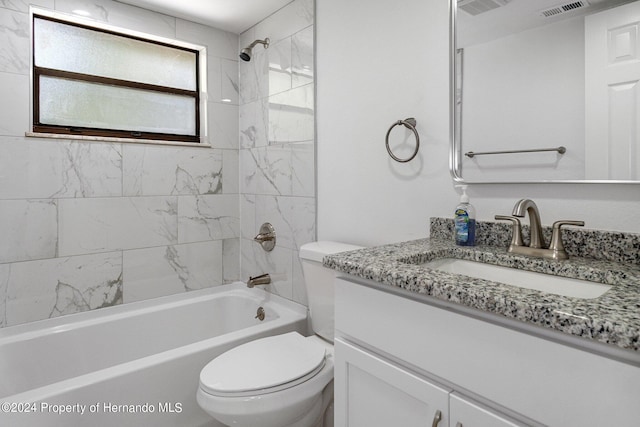 full bathroom with vanity, toilet, and tiled shower / bath combo