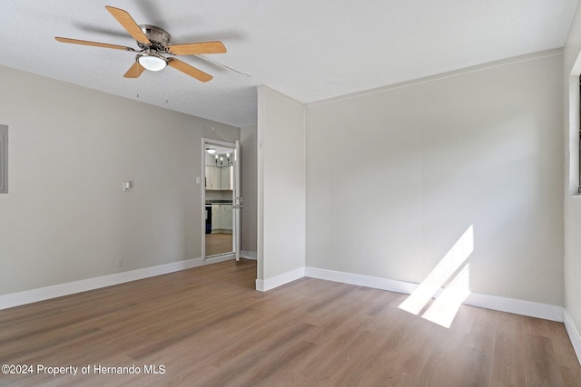 spare room with hardwood / wood-style flooring, ceiling fan, and a textured ceiling