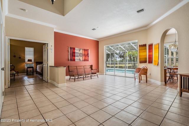 interior space with a wealth of natural light, a textured ceiling, and ornamental molding