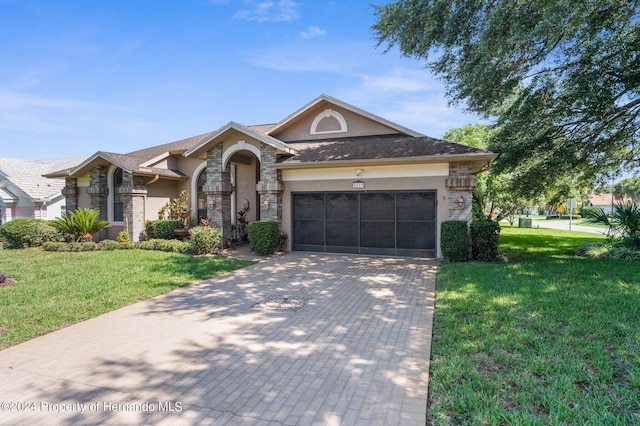 ranch-style house with a garage and a front lawn