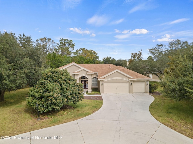 view of front facade featuring a garage and a front lawn