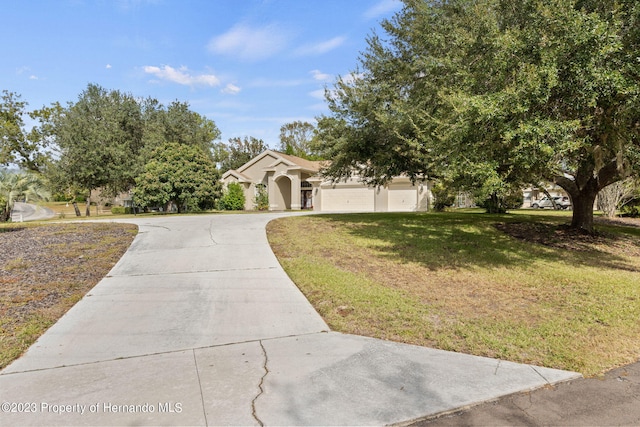 view of front of house with a garage and a front lawn