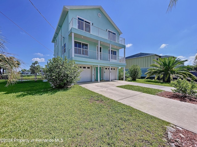 view of front of house featuring a garage and a front lawn