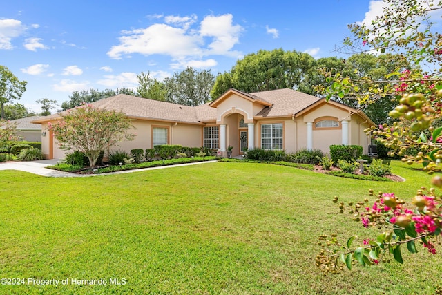 view of front of home featuring a garage and a front lawn