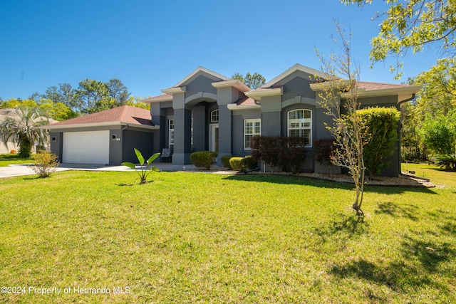 view of front of house with a garage and a front lawn