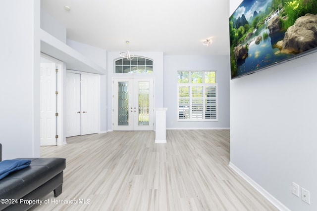 living room featuring light hardwood / wood-style flooring and french doors