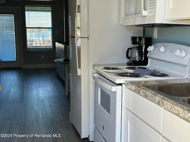 kitchen featuring white cabinetry, white appliances, and dark hardwood / wood-style floors