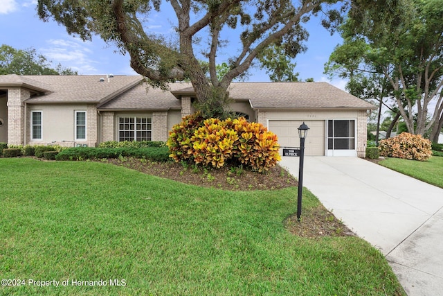 single story home with a garage and a front yard