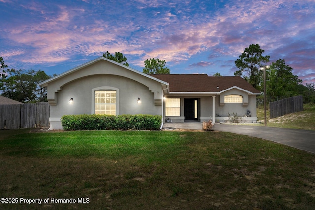 ranch-style house featuring a lawn