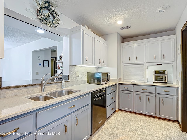 kitchen with white cabinets, decorative backsplash, dishwasher, a textured ceiling, and sink