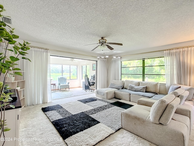 carpeted living room with a textured ceiling and ceiling fan