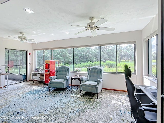 sunroom / solarium with a healthy amount of sunlight and ceiling fan