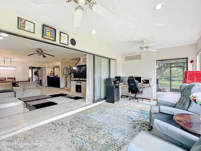 carpeted living room with ceiling fan