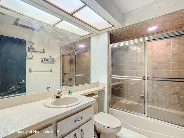 full bathroom with toilet, combined bath / shower with glass door, and vanity