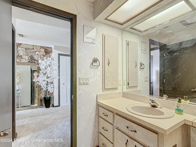 bathroom featuring vanity and a textured ceiling