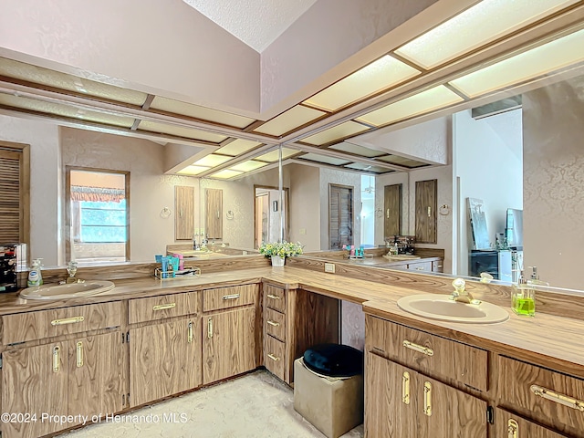 bathroom with vanity and a textured ceiling