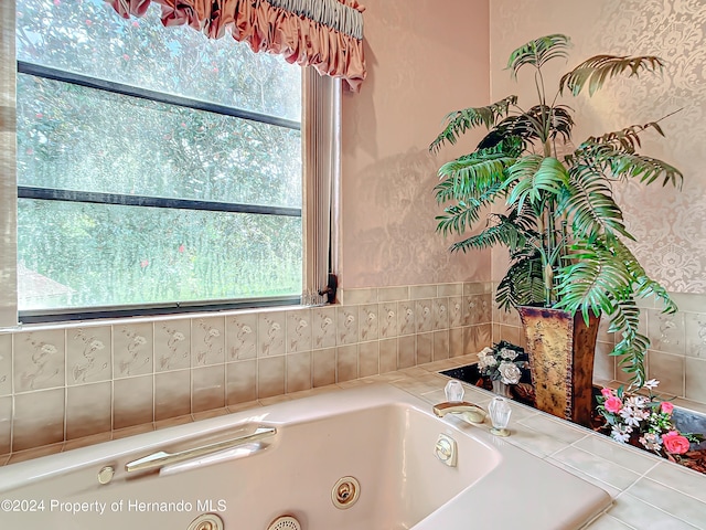 bathroom featuring a tub to relax in and plenty of natural light