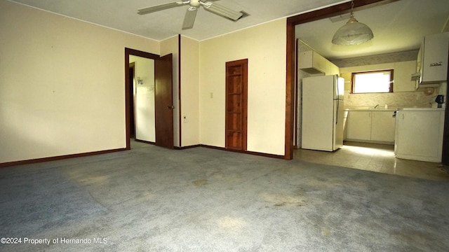 spare room with light colored carpet and ceiling fan