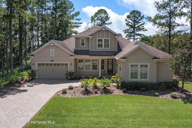 craftsman-style home with a front lawn and a garage