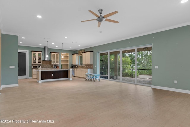 unfurnished living room featuring ceiling fan, light wood-type flooring, and ornamental molding