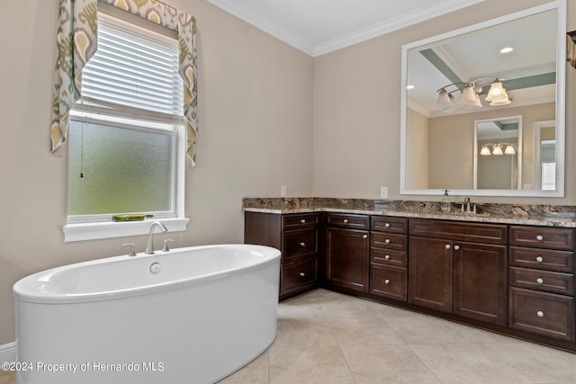 bathroom featuring a bathtub, vanity, tile patterned flooring, and ornamental molding