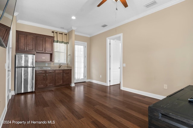 kitchen with stainless steel refrigerator, sink, ceiling fan, crown molding, and dark wood-type flooring