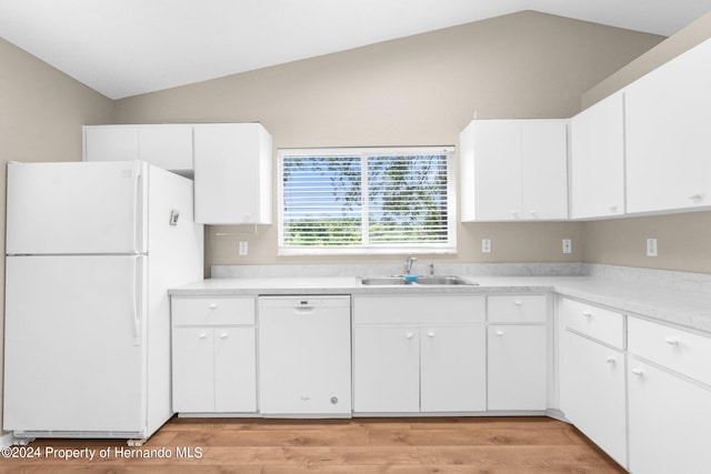 kitchen featuring vaulted ceiling, sink, white cabinets, and white appliances