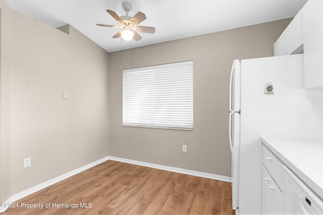 kitchen with white cabinets, ceiling fan, white refrigerator, and light wood-type flooring