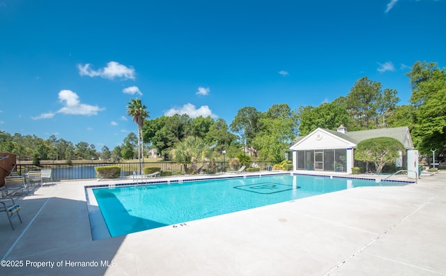 view of pool with a water view and a patio area