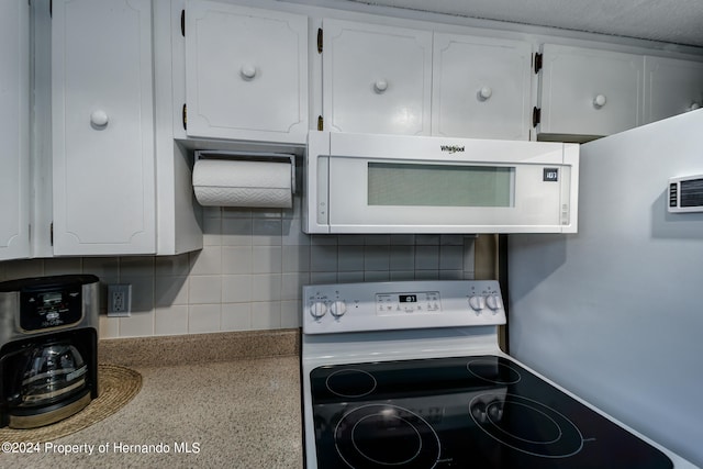 kitchen with white cabinetry, white appliances, a textured ceiling, and backsplash