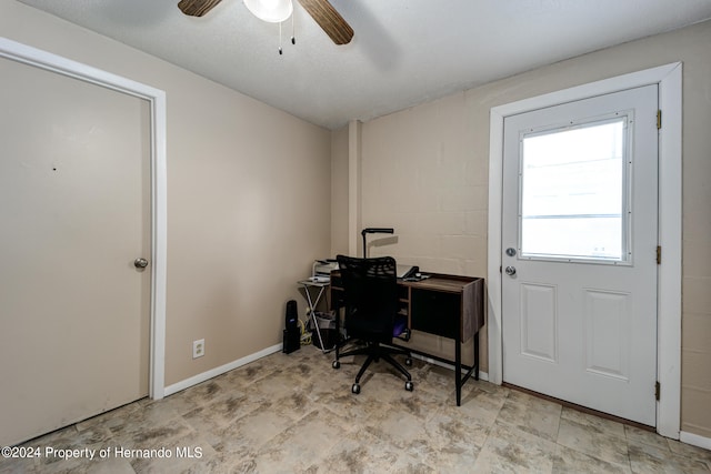 office area with ceiling fan and a textured ceiling