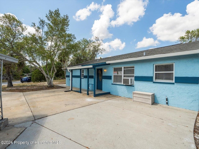 back of property featuring cooling unit and a patio area