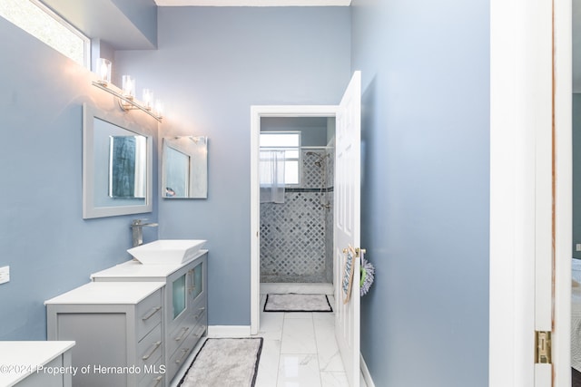 bathroom with a shower with shower door and vanity