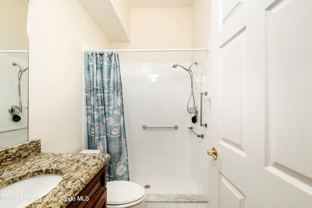 bathroom featuring walk in shower, vanity, and toilet