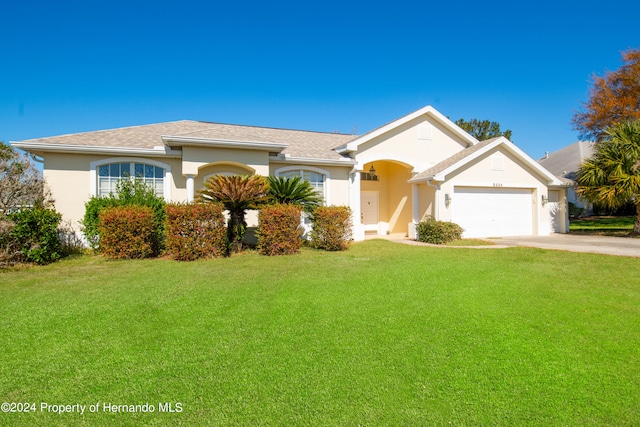 ranch-style house with a garage and a front yard