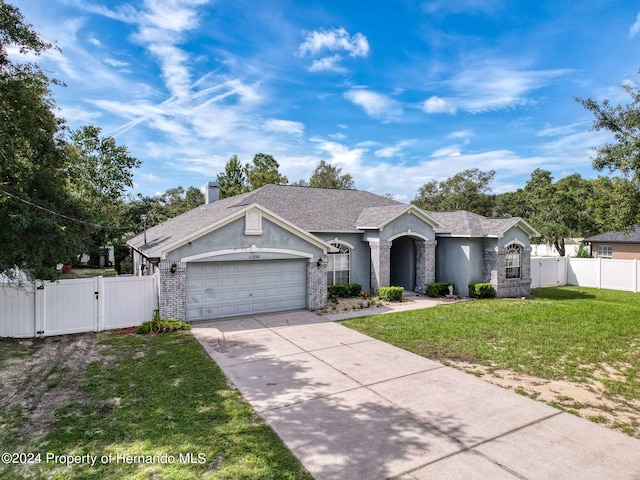 ranch-style house with a front lawn and a garage