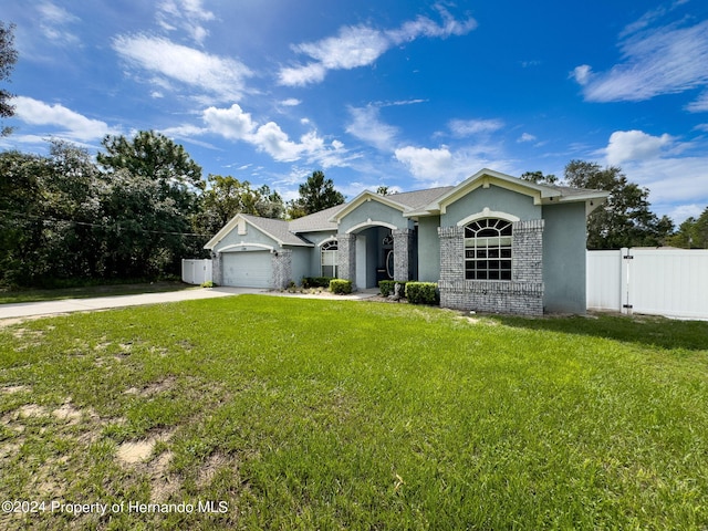 ranch-style house with a garage and a front lawn