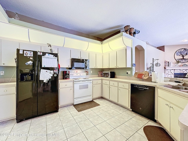 kitchen featuring black appliances, sink, a textured ceiling, and light tile patterned floors