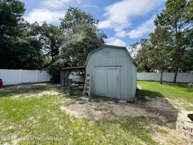 view of outbuilding with a lawn