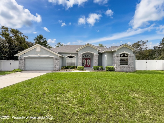 single story home with a garage and a front yard