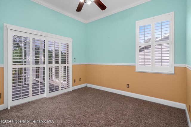 unfurnished room with carpet, ceiling fan, and crown molding