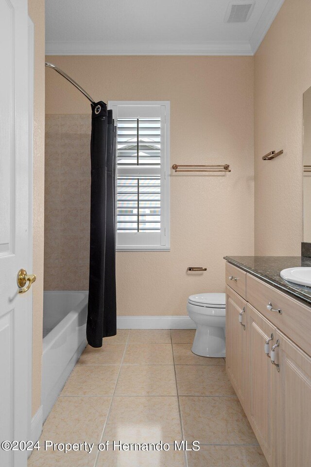 full bathroom with toilet, tile patterned flooring, vanity, crown molding, and shower / tub combo with curtain