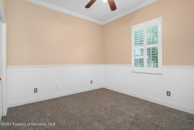 unfurnished room featuring ceiling fan, carpet flooring, and crown molding