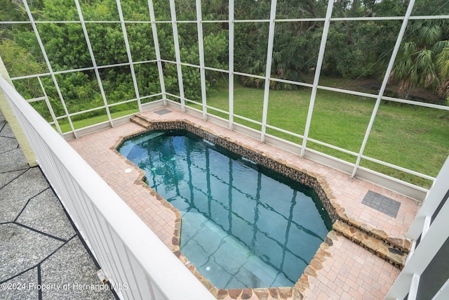 view of pool with a lawn and a patio area