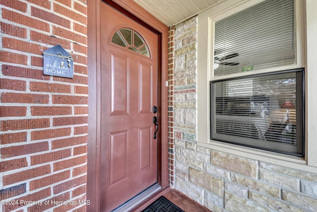 6635 Stewart Ave N, Saint Petersburg, FL 33702 - doorway to property with a porch and brick siding