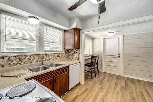 6635 Stewart Ave N, Saint Petersburg, FL 33702 - kitchen featuring dishwasher, a sink, a textured ceiling, light wood finished floors, and ceiling fan